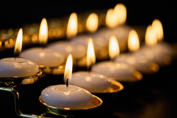 Row of glowing candles creating a warm and peaceful ambiance.