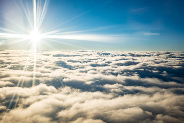 Looking out the airplane window, admiring the blue sky and clouds