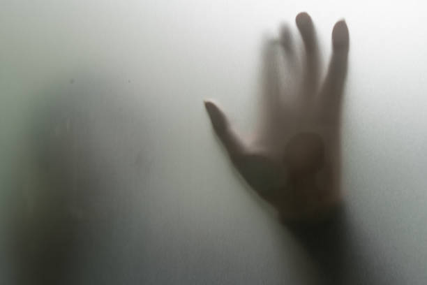 istock human hand on frosted glass backlit 2195784375