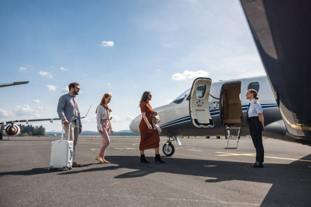 istock Family Being Greeted by Pilot While Boarding Private Jet 2195789425