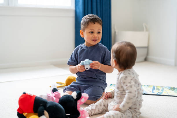 istock Brother and sister playing together at home 2195797484