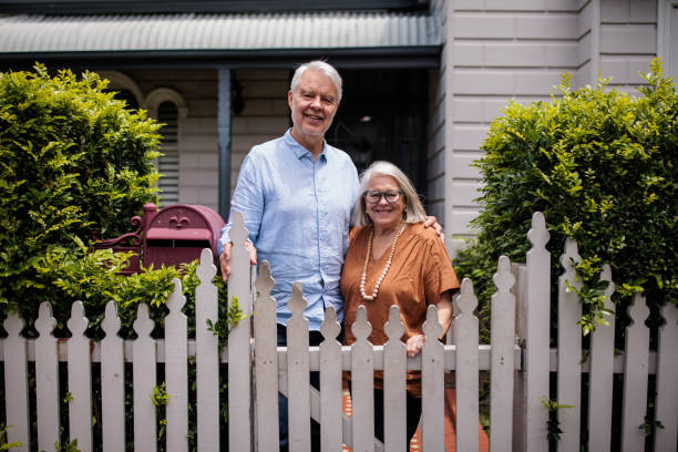 istock Elderly Couple in Front of Their House 2195803433
