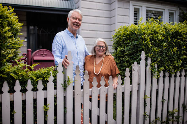 istock Elderly Couple in Front of Their House 2195803443