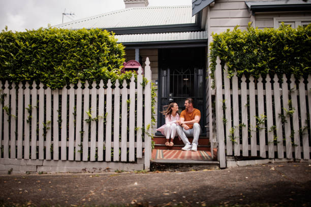 istock Couple Sitting on Their Porch Steps 2195803480