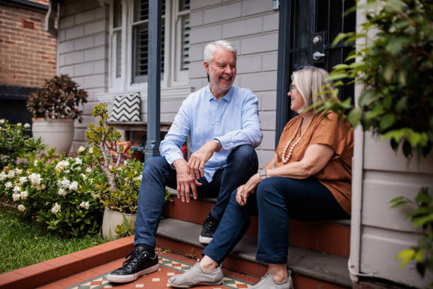 istock Senior Couple Sitting on Their Porch Steps 2195803512