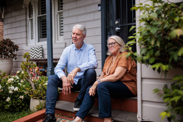 istock Senior Couple Sitting on Their Porch Steps 2195803541