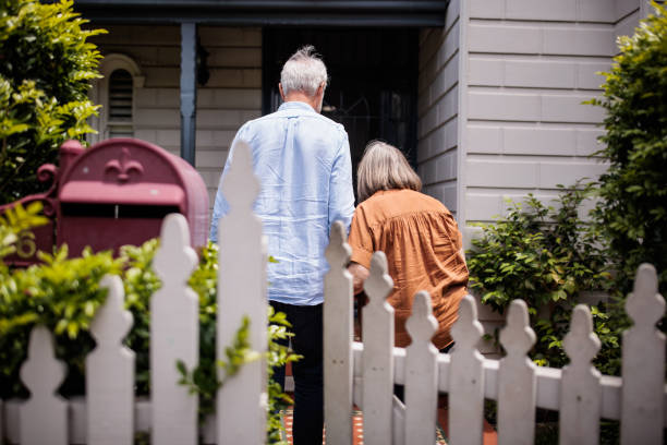 istock Elderly Couple Approaching Their Front Door 2195803579