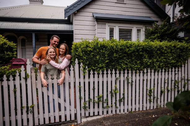 istock Family standing outside their lovely home 2195803873