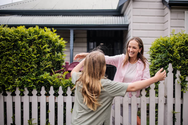 istock Mother Greets Daughter at the Fence 2195803951