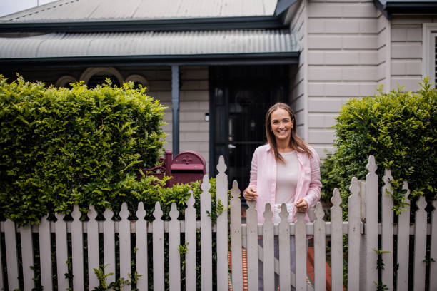 Woman standing in front of her home