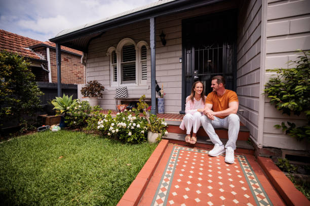 istock Couple Relaxing on Their Porch Steps 2195804477