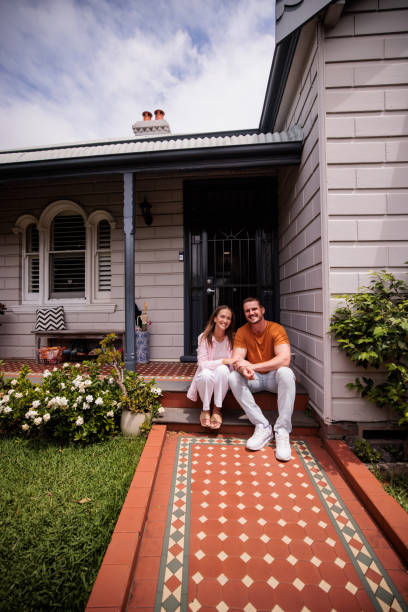 istock Couple Relaxing on Their Porch Steps 2195804485