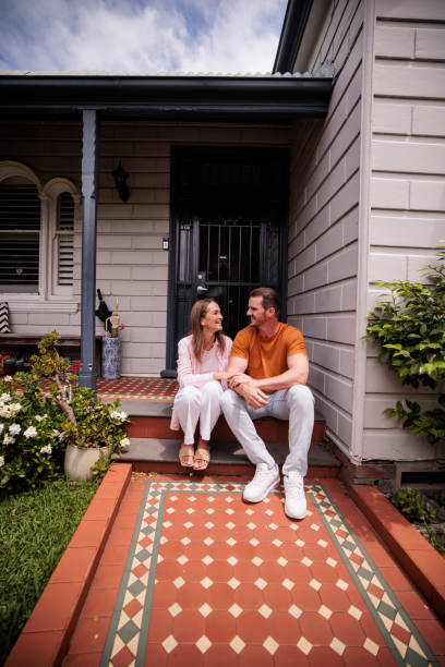 istock Couple Relaxing on Their Porch Steps 2195804498