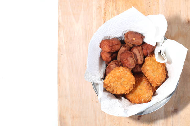 nuggets and sausages in bowl isolated on white background
