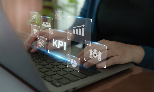 istock KPI and data metrics on laptop. Working on a laptop with digital icons KPI, analytics, and business performance metrics. Modern technology and data driven decision making in business strategy. 2195808161