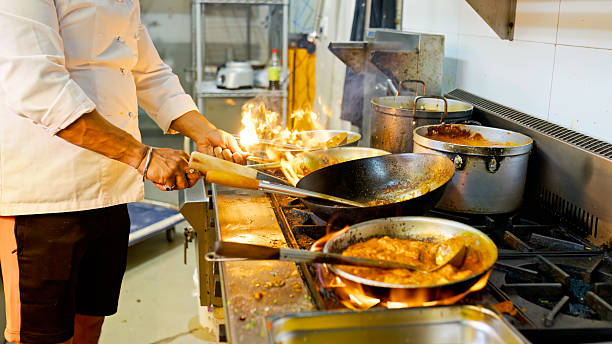 istock Head Chef Cooking Dishes on Woks inside Indian Restaurant Kitchen in Sydney, Australia 2195808621