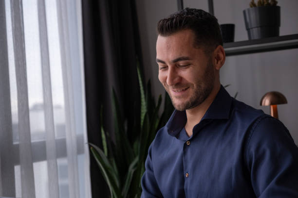 istock Young businessman smiling while working from home office 2195808851