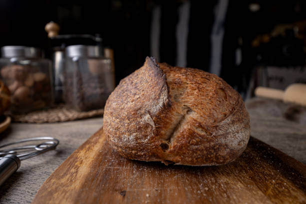 istock Golden-Crusted Artisan Sourdough Bread on a Rustic Wooden Table. 2195809050