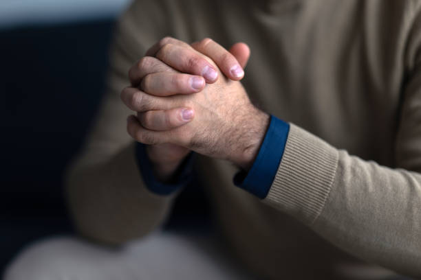 istock Businessman clasping hands in thoughtful contemplation 2195809159