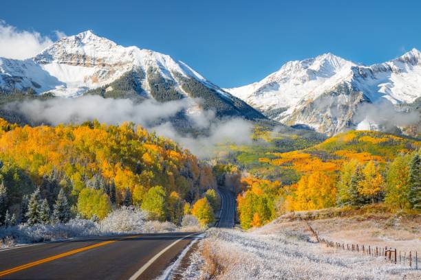 istock Scenic autumn landscape with winding road and mountains. 2195809676