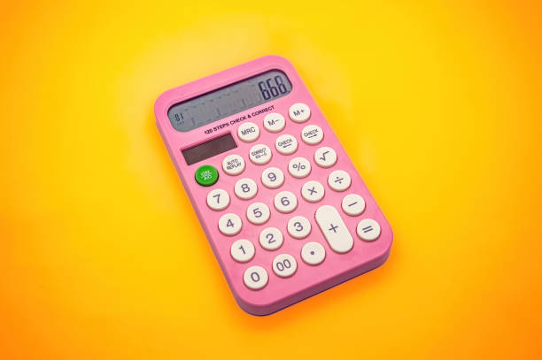 istock A pink calculator with white buttons on a vibrant yellow background. The display shows the number 666, making it a visually striking and colorful image 2195809997
