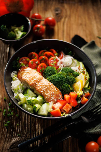 istock Salmon bowl with mix vegetables and rice, top view. 2195813353