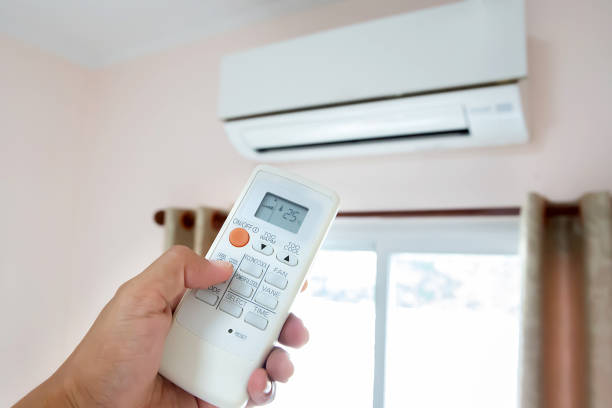 istock Close up hand and remote control air condition. 2195813415