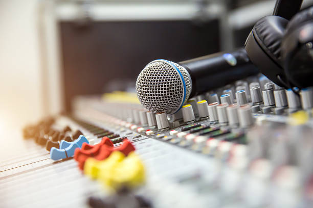 istock Close-up the microphone is placed on the professional audio mixer at studio for live the media and sound equipment production concept. 2195813454