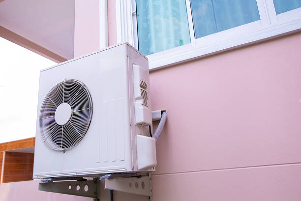 istock External air conditioner compressor unit are installed on the outside wall of the building. 2195813557