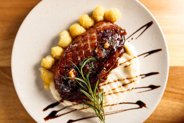 istock Exquisite Plated Crispy Duck Dish with Mashed Potatoes and Artistic Garnish 2195814406