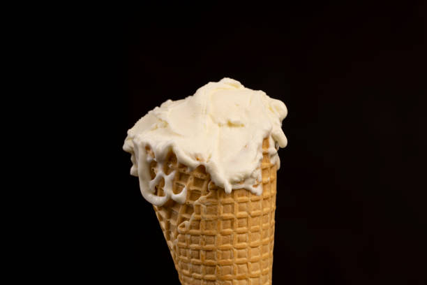 istock creamy ice cream in a waffle cone on a black background 2195816503