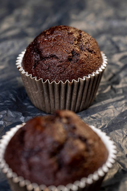 istock fresh and soft black chocolate cupcake on black paper 2195816614