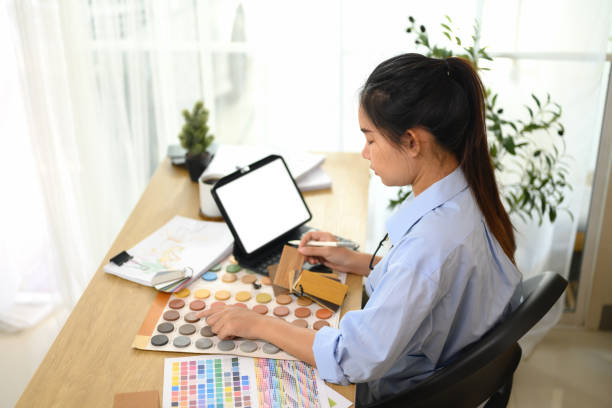 istock Female designer focused on selecting colors and materials home renovation project 2195817004