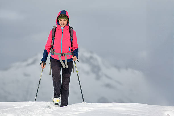 In late June this year, there is still a lot of snow on the trail leading to the lake called La Vecchia, the thaw being late.  A young woman in a hat climbs up the snowdrift. The lake is located on the border between Piedmont, Cervo Valley, and Aosta Valley, Lys Valley. The mountain range embracing the lake appears majestic, steep, and mighty.