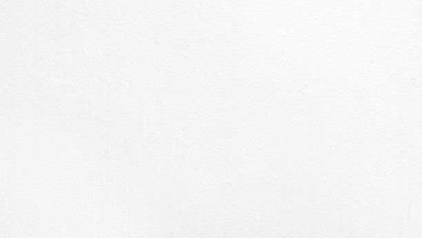 istock close-up view of a light white wall with a subtle, fine-grained texture, creating a modern and inviting. white backdrop with a slightly rough wall. 2195820492