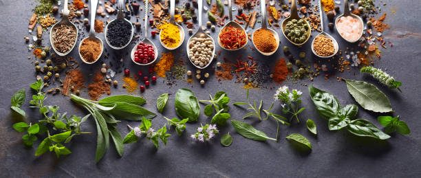 istock Spices and herbs in closeup on black background 2195821225