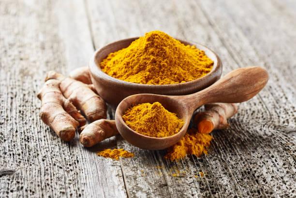 istock Turmeric root and powder on wooden background 2195821516