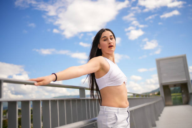 istock Woman leaning on a rail while dancing urban music 2195821790