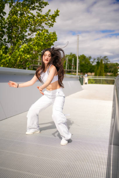 istock Woman dancing energetically while dancing urban music 2195821802