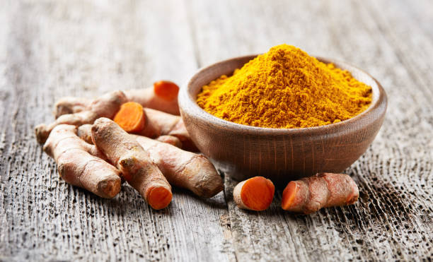 istock Turmeric root and powder on wooden board 2195821985