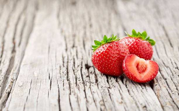 istock Ripe strawberry on wooden background 2195822377