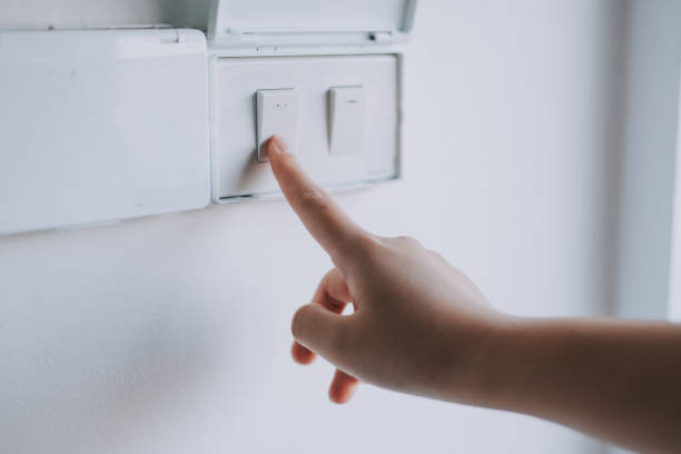 istock Turn off the lights in the room with the switch on the wall. 2195827710