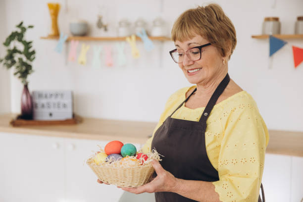 istock Happy Easter! Cute retired old woman painted easter egg. DIY craft easter eggs 2195828534
