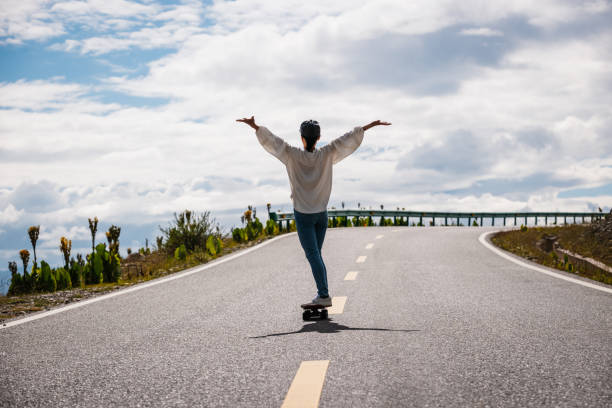 Skateboarder skateboarding on the mountain road
