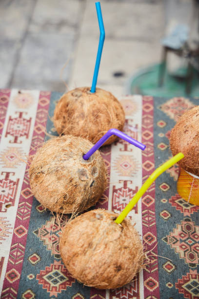 Drink in coconut with a straw. Coconut juice.