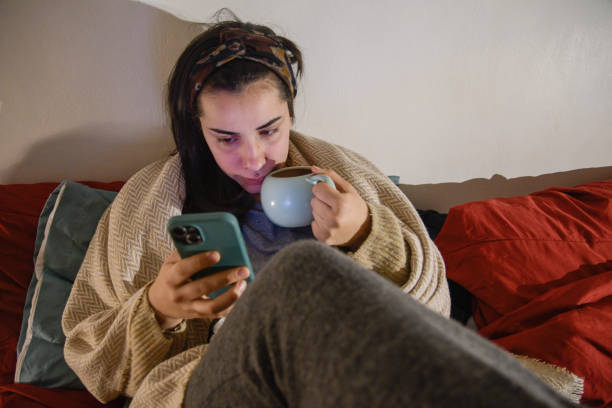 istock Ill young woman contacting a doctor via smartphone while resting 2195831353