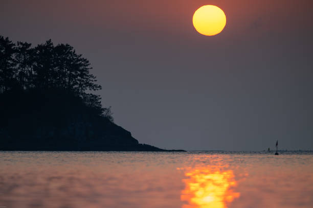 A breathtaking sunrise rising over the beautiful Chudo Island in Namhae.