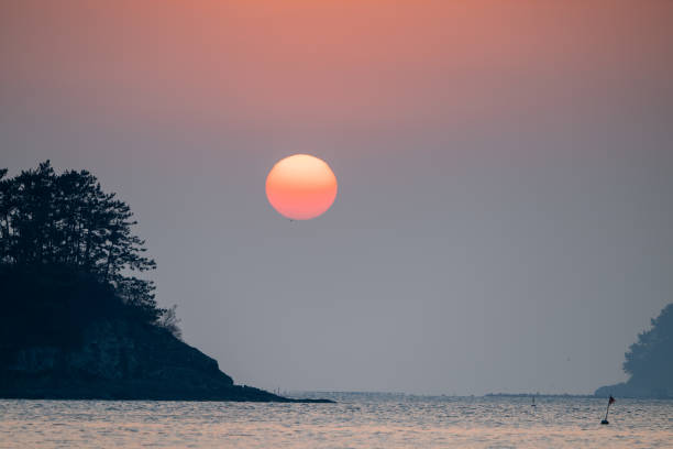 A breathtaking sunrise rising over the beautiful Chudo Island in Namhae.