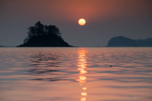 A breathtaking sunrise rising over the beautiful Chudo Island in Namhae.