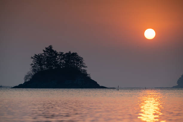 A breathtaking sunrise rising over the beautiful Chudo Island in Namhae.